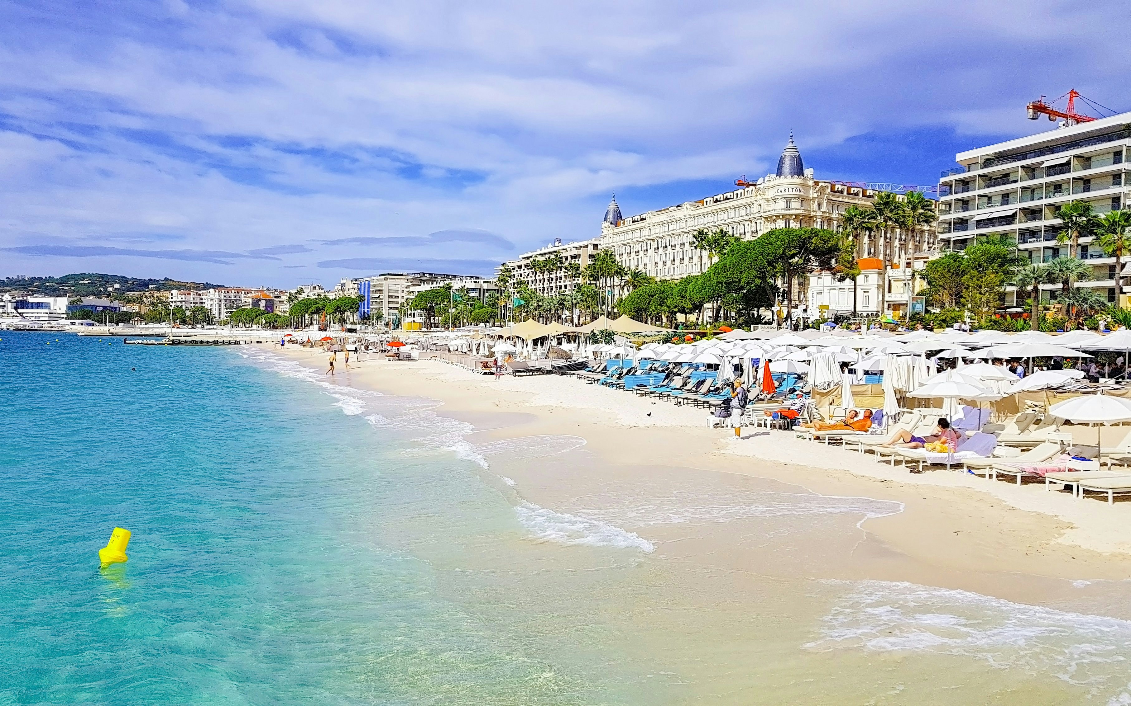 Beachfront with sun loungers and umbrellas in Cannes, French Riviera.