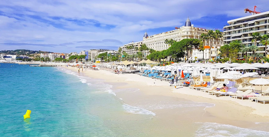 Beachfront with sun loungers and umbrellas in Cannes, French Riviera.