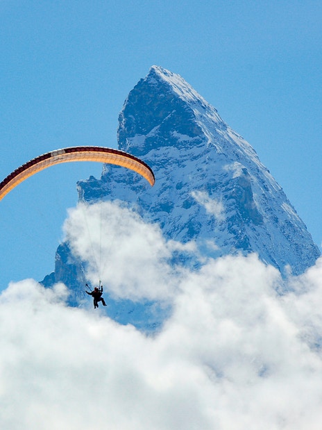 Paraglider soaring near the Matterhorn in Zermatt, Switzerland.