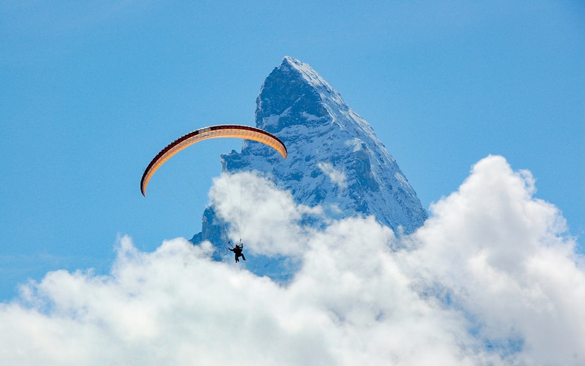 Paraglider soaring near the Matterhorn in Zermatt, Switzerland.