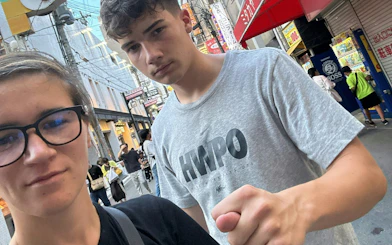 Exploring Dotonbori street in Osaka during a self-guided food origins game.