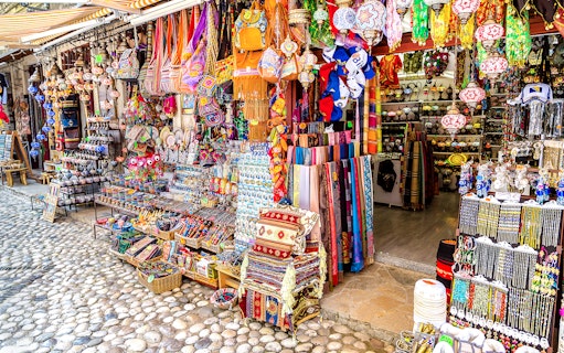 Colorful market stall with traditional crafts and textiles in Mostar, Bosnia and Herzegovina.