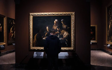 Visitor viewing a painting at Pinacoteca di Brera, Milan, during a self-guided audio tour.