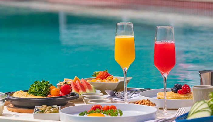 Breakfast in swimming pool, floating breakfast in luxurious tropical resort.