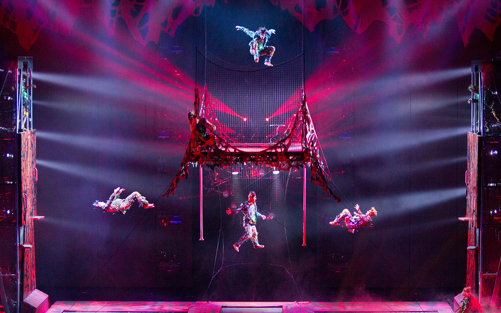 Acrobats performing in Michael Jackson ONE show with vibrant lighting effects.