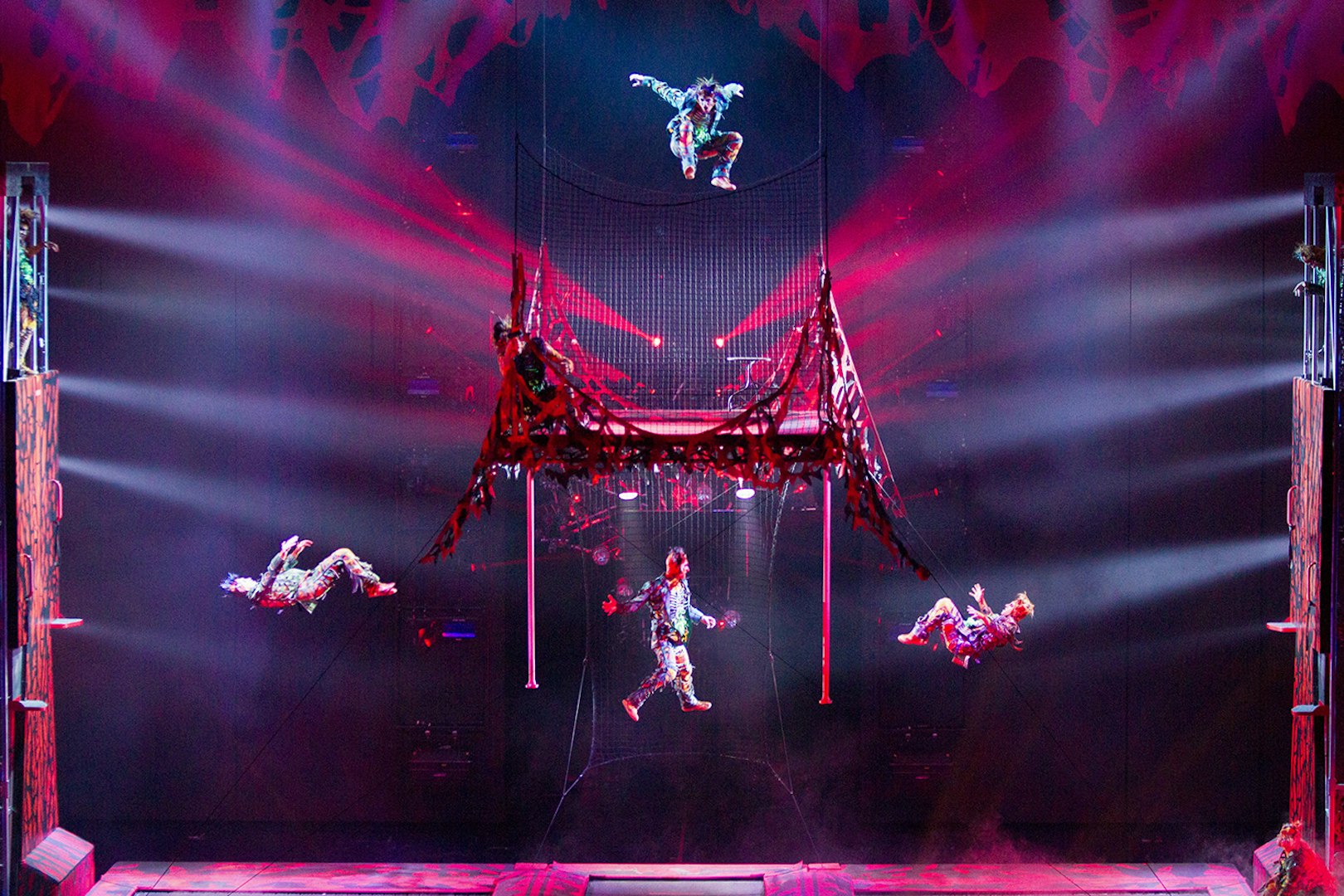 Acrobats performing in Michael Jackson ONE show with vibrant lighting effects.