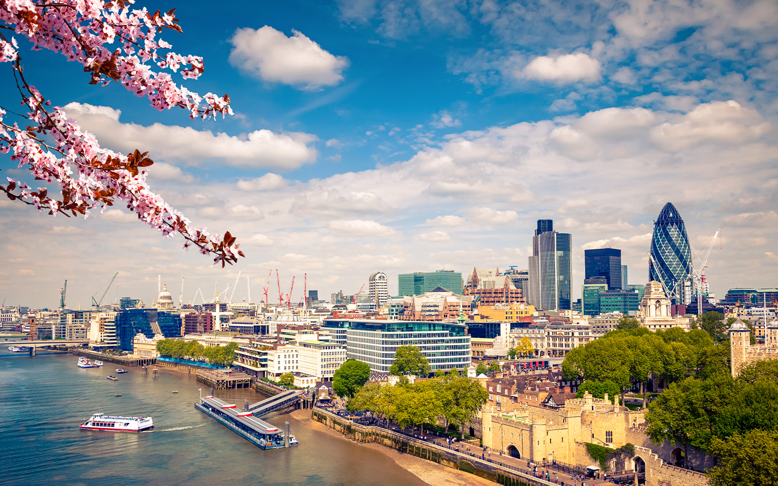 Skyline view of London with Embankment Pier and the Gherkin building.