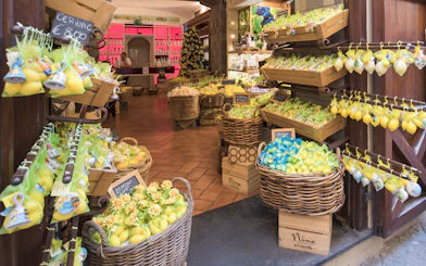 Souvenir shop in Sorrento, Italy with baskets of lemon-themed gifts and ceramics.