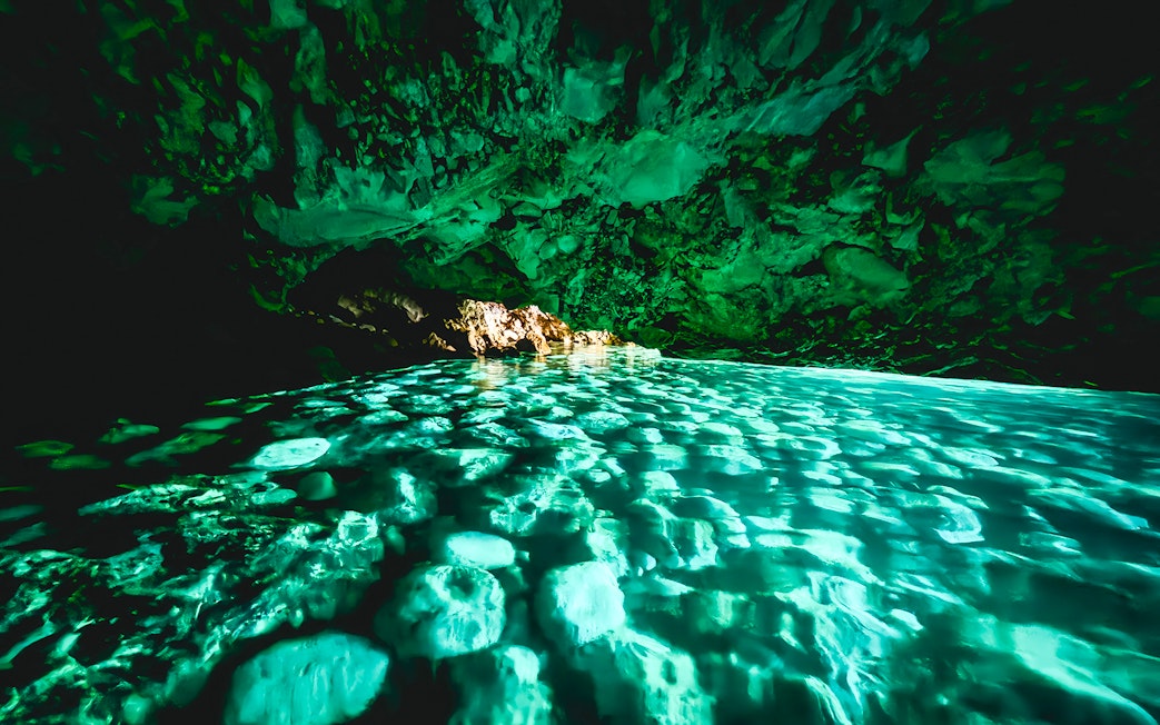 Blue cave interior with turquoise water reflections, Albania.