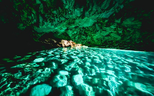 Blue cave interior with turquoise water reflections, Albania.
