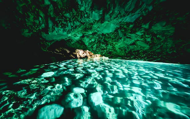 Blue cave interior with turquoise water reflections, Albania.