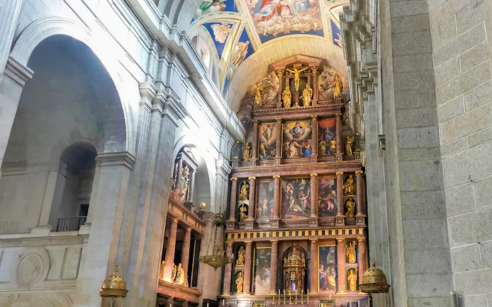 Altarpiece in Basilica of San Lorenzo, El Escorial, featuring religious artwork and sculptures.