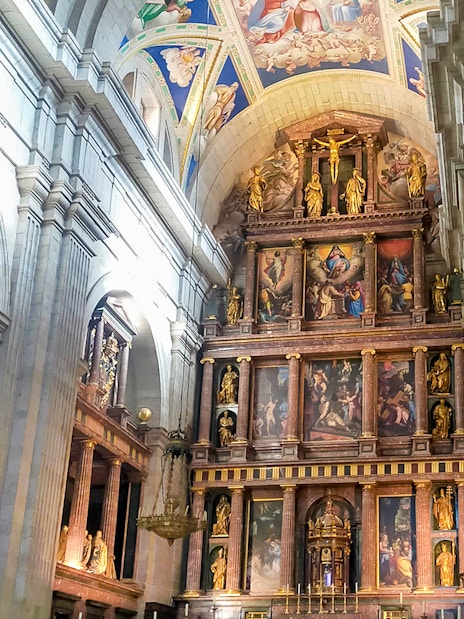 Altarpiece in Basilica of San Lorenzo, El Escorial, featuring religious artwork and sculptures.