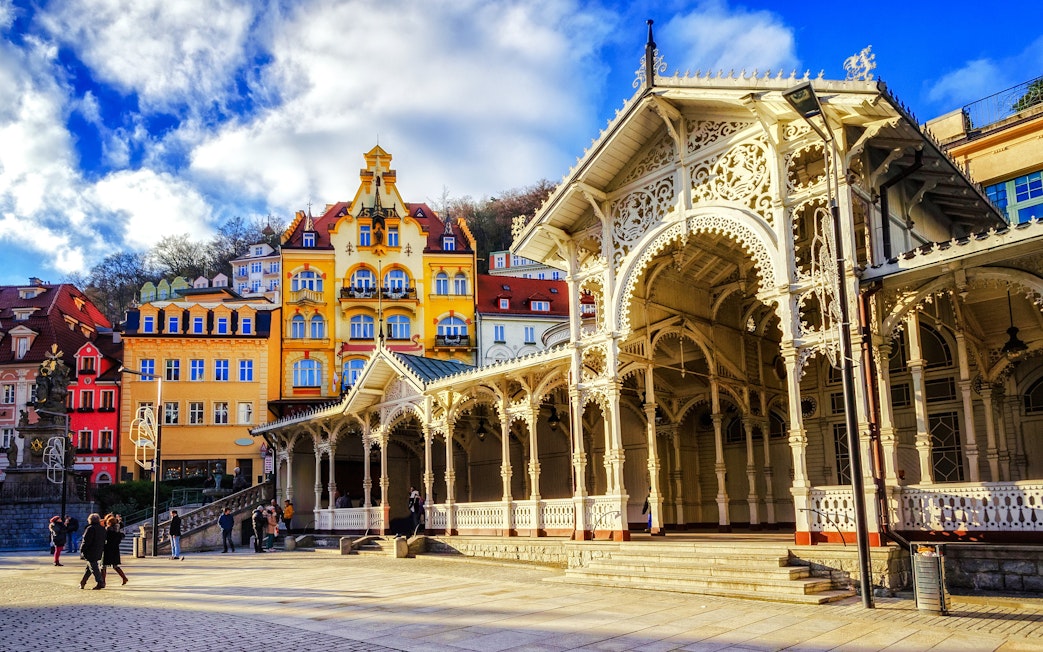Historic colonnade and colorful buildings in Karlovy Vary street view.