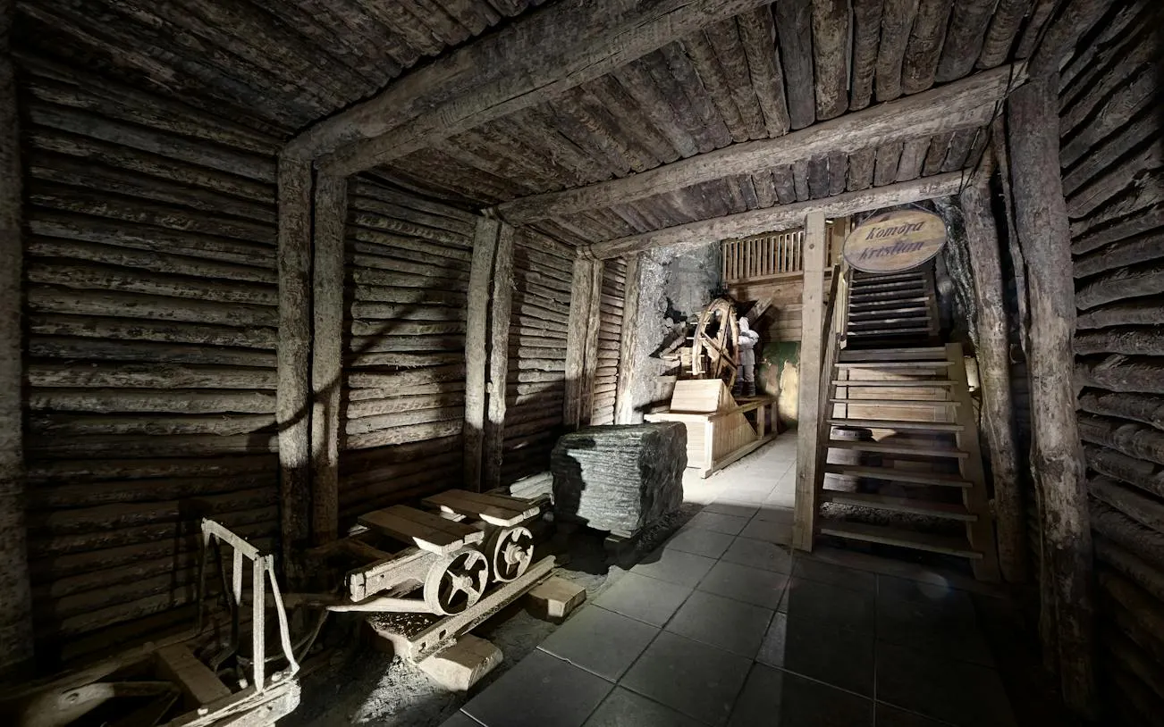 Bochnia Salt Mine wooden interior with mining cart and stairs, Krakow tour.
