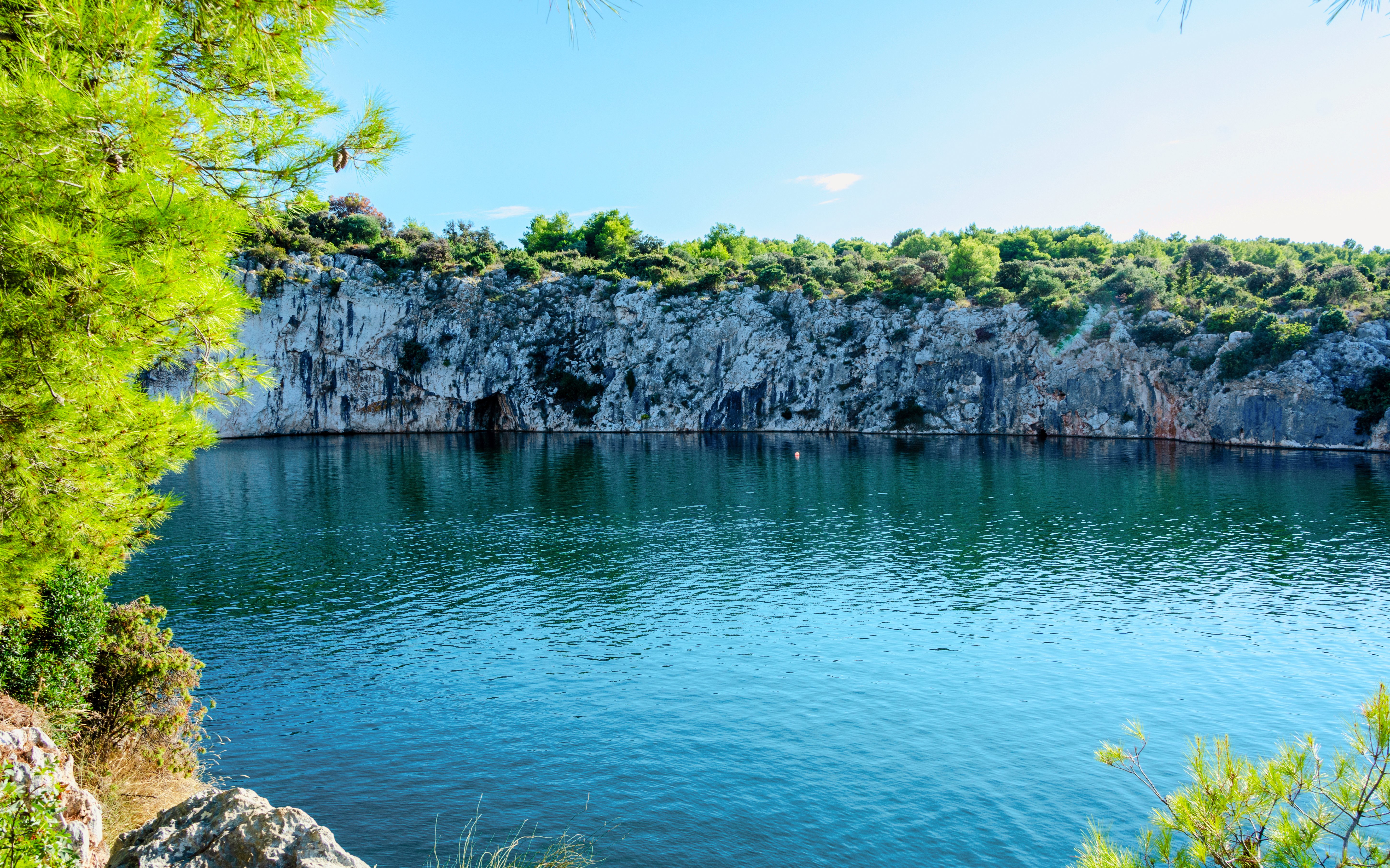 Dragon’s Eye lake with rocky cliffs and greenery in Rogoznica, Croatia.