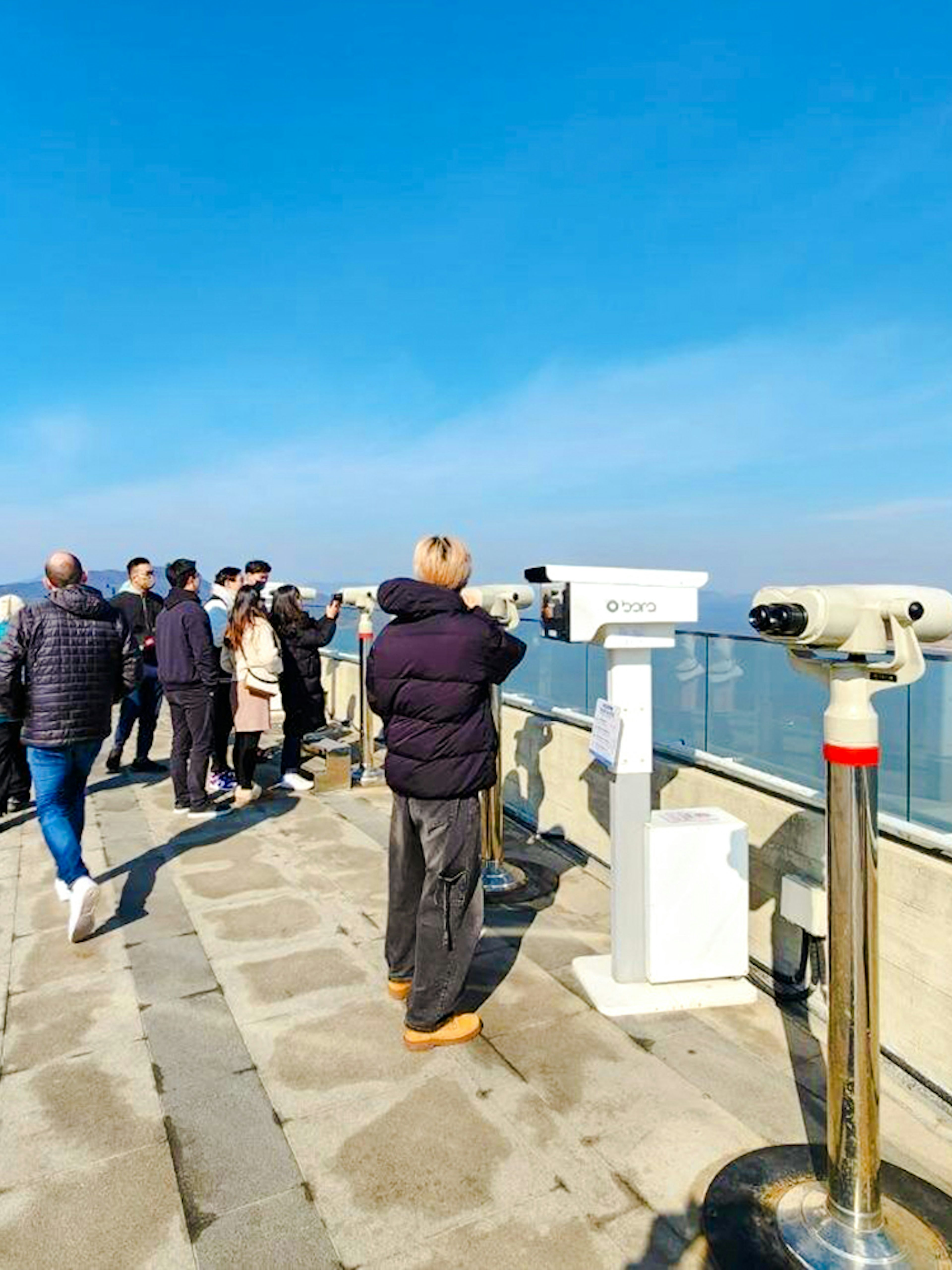 Visitors at Aegibong Observatory viewing DMZ landscape, South Korea.