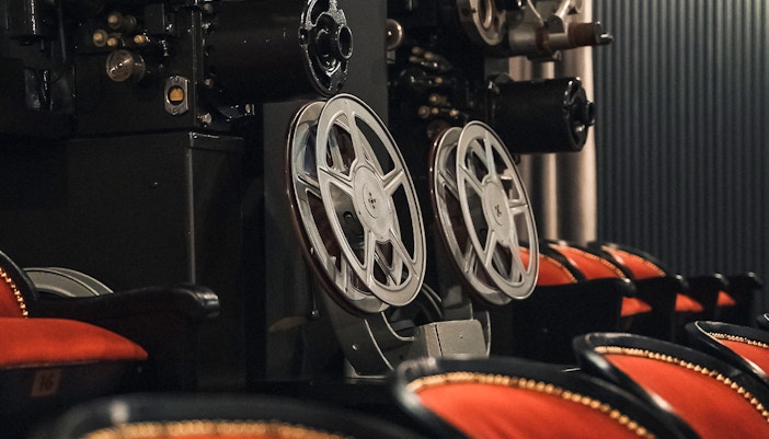 film projector and red theater seats