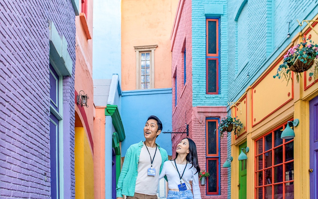 Couple exploring colorful alley at Universal Studios Hollywood.