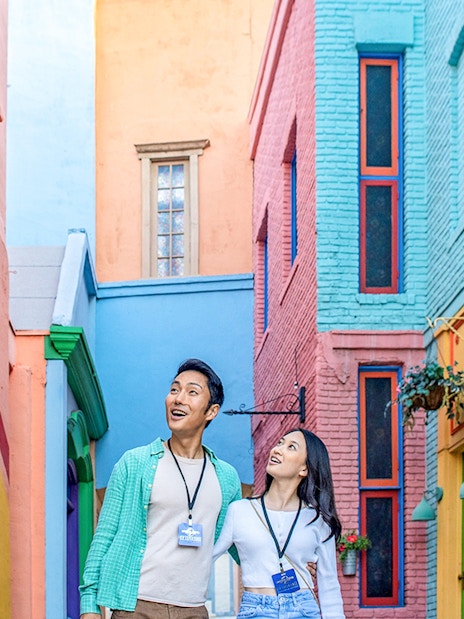 Couple exploring colorful alley at Universal Studios Hollywood.