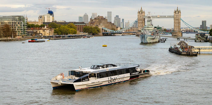 Uber Boat on Thames River near Tower Bridge, London.