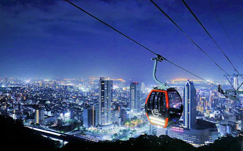 Kobe cityscape with ropeway gondola to Nunobiki Herb Gardens at night.