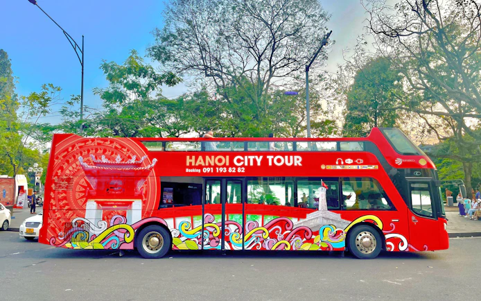Hop on hop off tour bus in Hanoi, Vietnam with vibrant cityscape design.