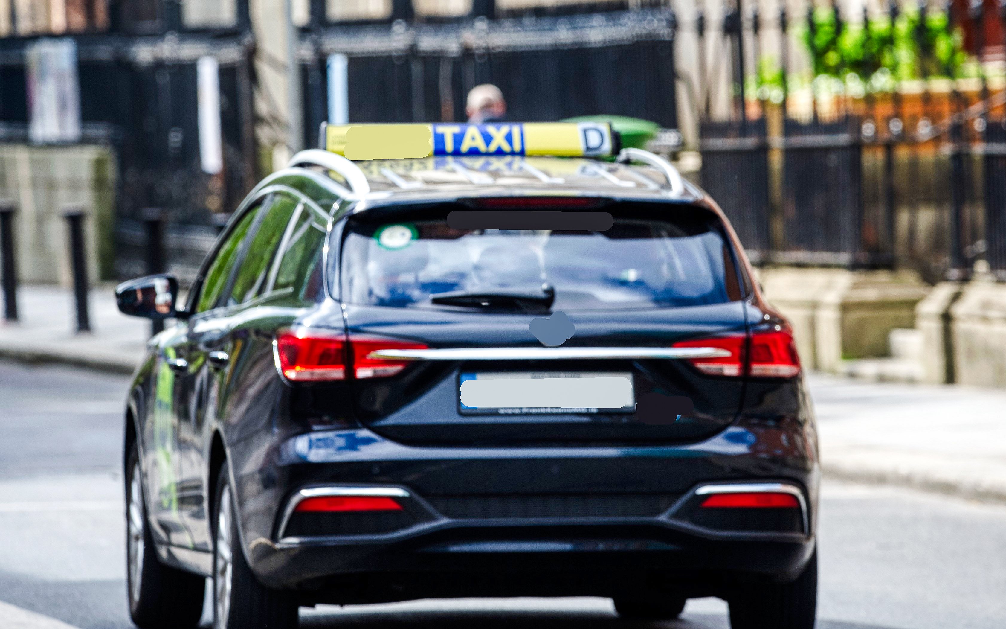 Taxi driving through a street in Ireland.