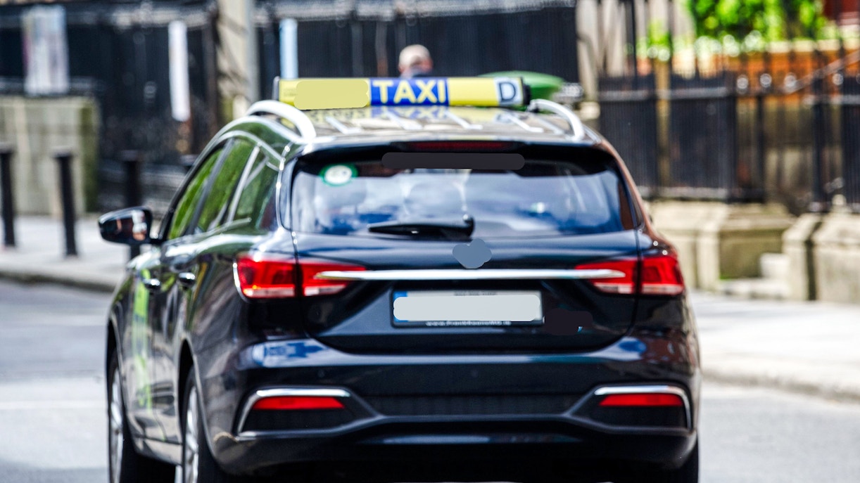 Taxi driving through a street in Ireland.