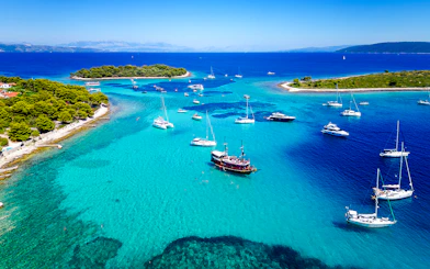Boats anchored in the clear waters of Blue Lagoon, Croatia, near the underwater museum.