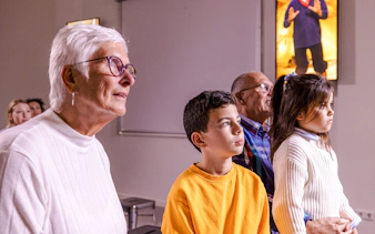 Visitors watching a film at the Kinderdijk exhibition.
