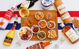 Traditional Dutch drinks and snacks on a wooden board, Amsterdam.