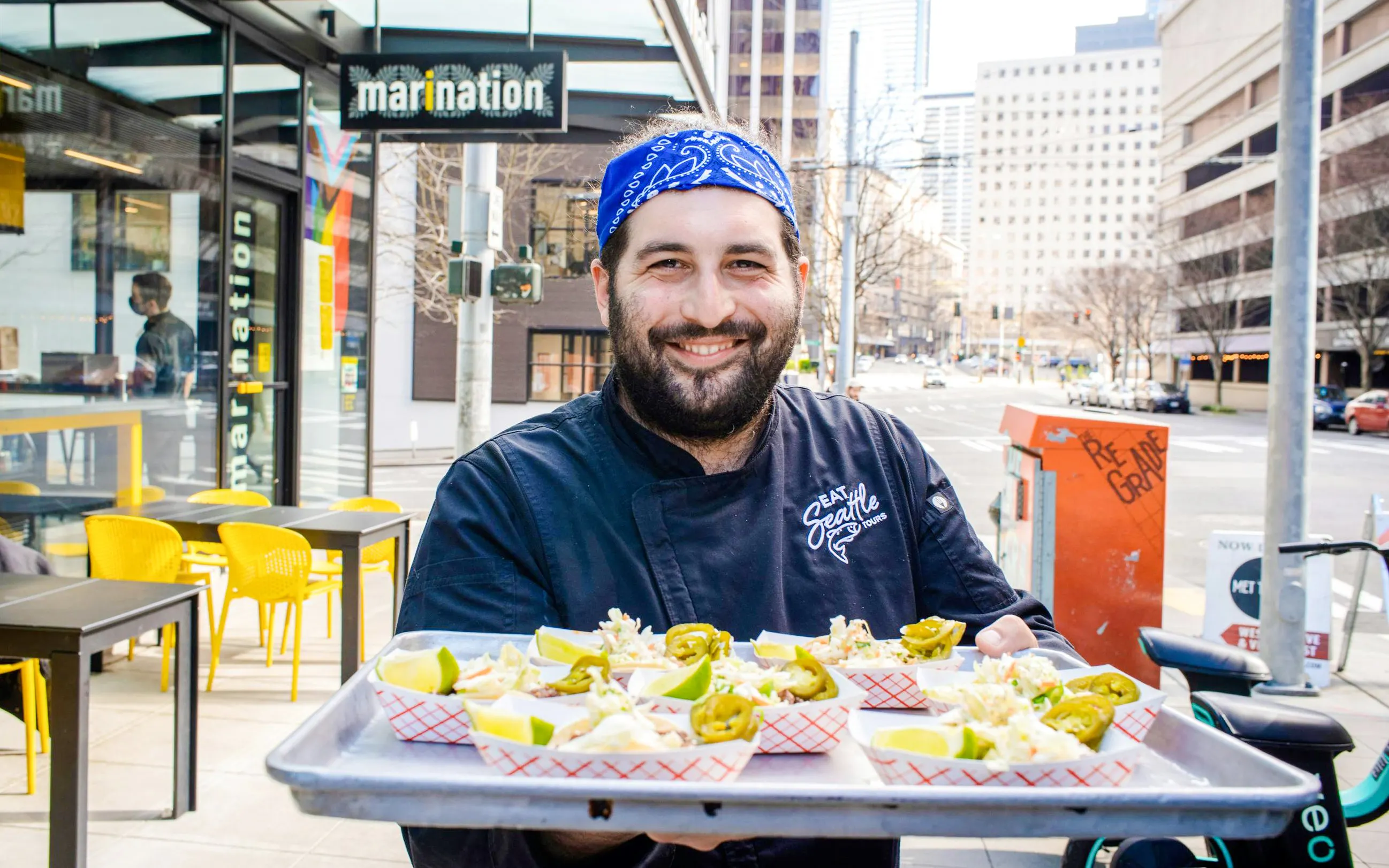 Chef presenting street food samples on a tray in South Lake Union.