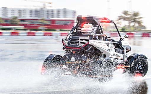 Polaris vehicle drifting on wet track at YAS Marina Circuit.