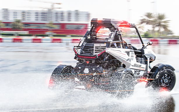 Polaris vehicle drifting on wet track at YAS Marina Circuit.