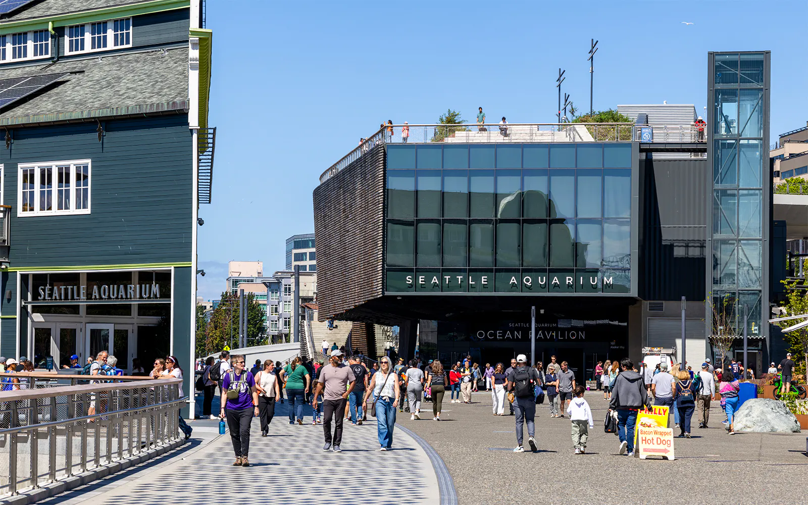 Seattle Aquarium entrance with visitors walking outside in Seattle.