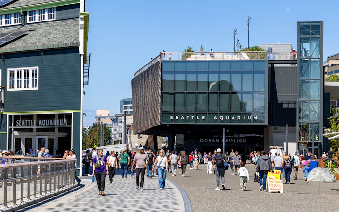 Seattle Aquarium entrance with visitors walking outside in Seattle.