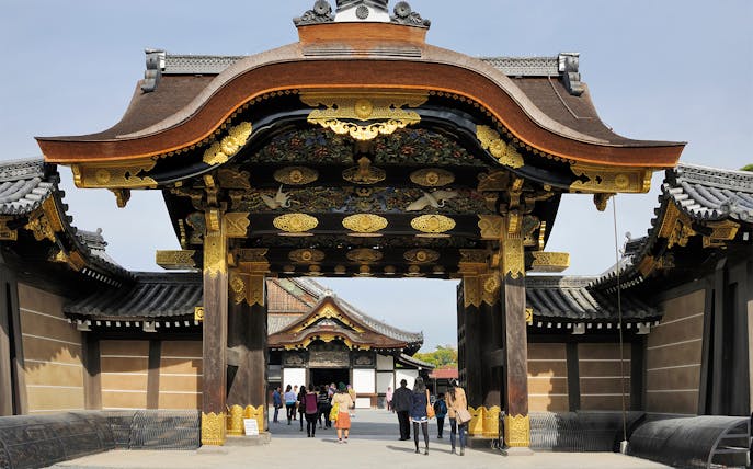 Nijo Castle entrance in Kyoto with tourists exploring the heritage site.