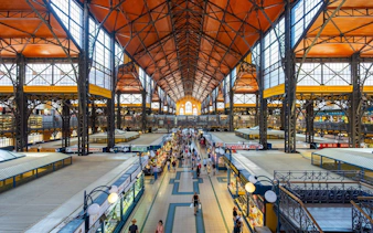 Central Market Hall in Budapest bustling with visitors exploring food stalls.