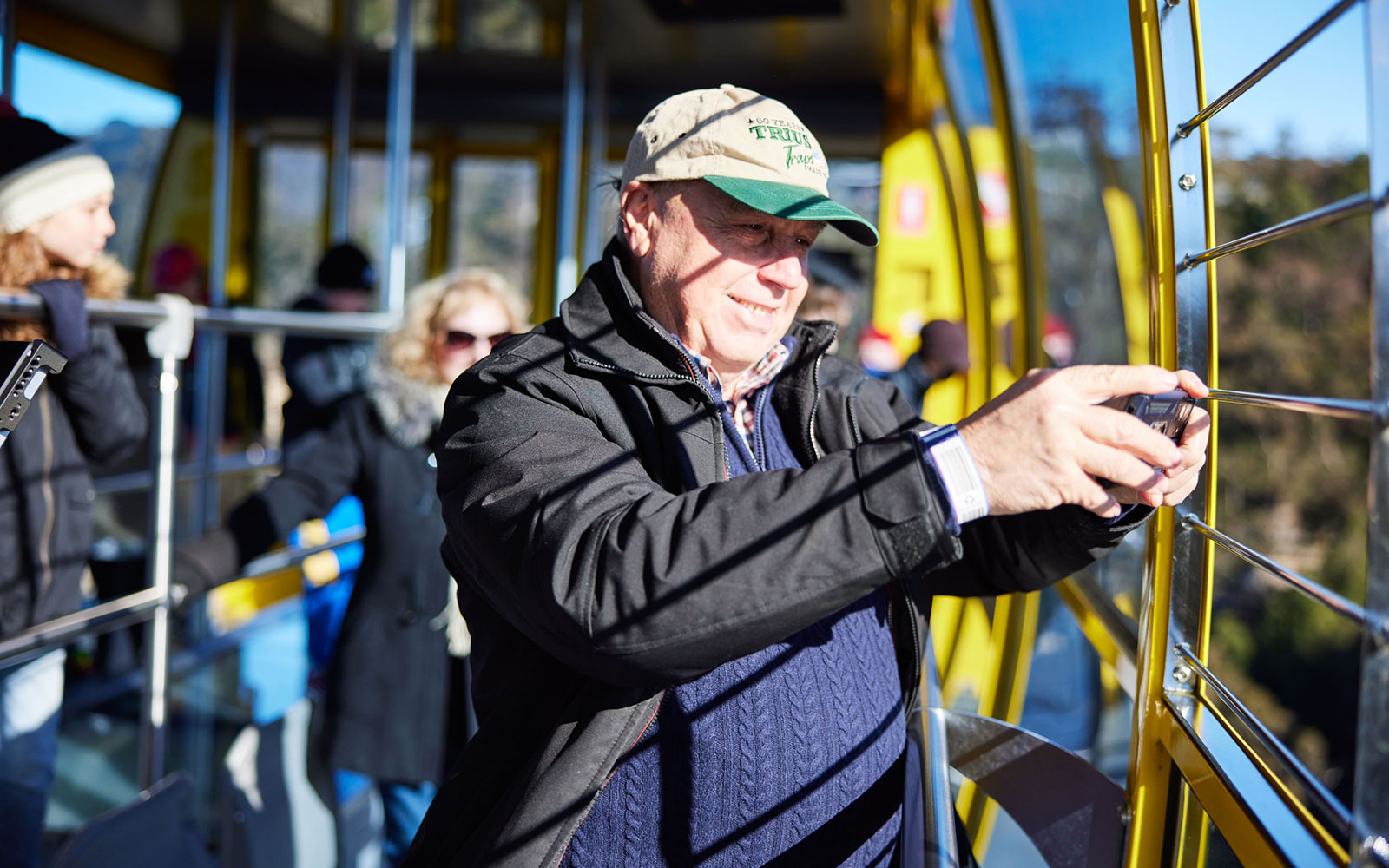 Visitor photographing views from an aerial cable car at Scenic World, Blue Mountains, Australia.