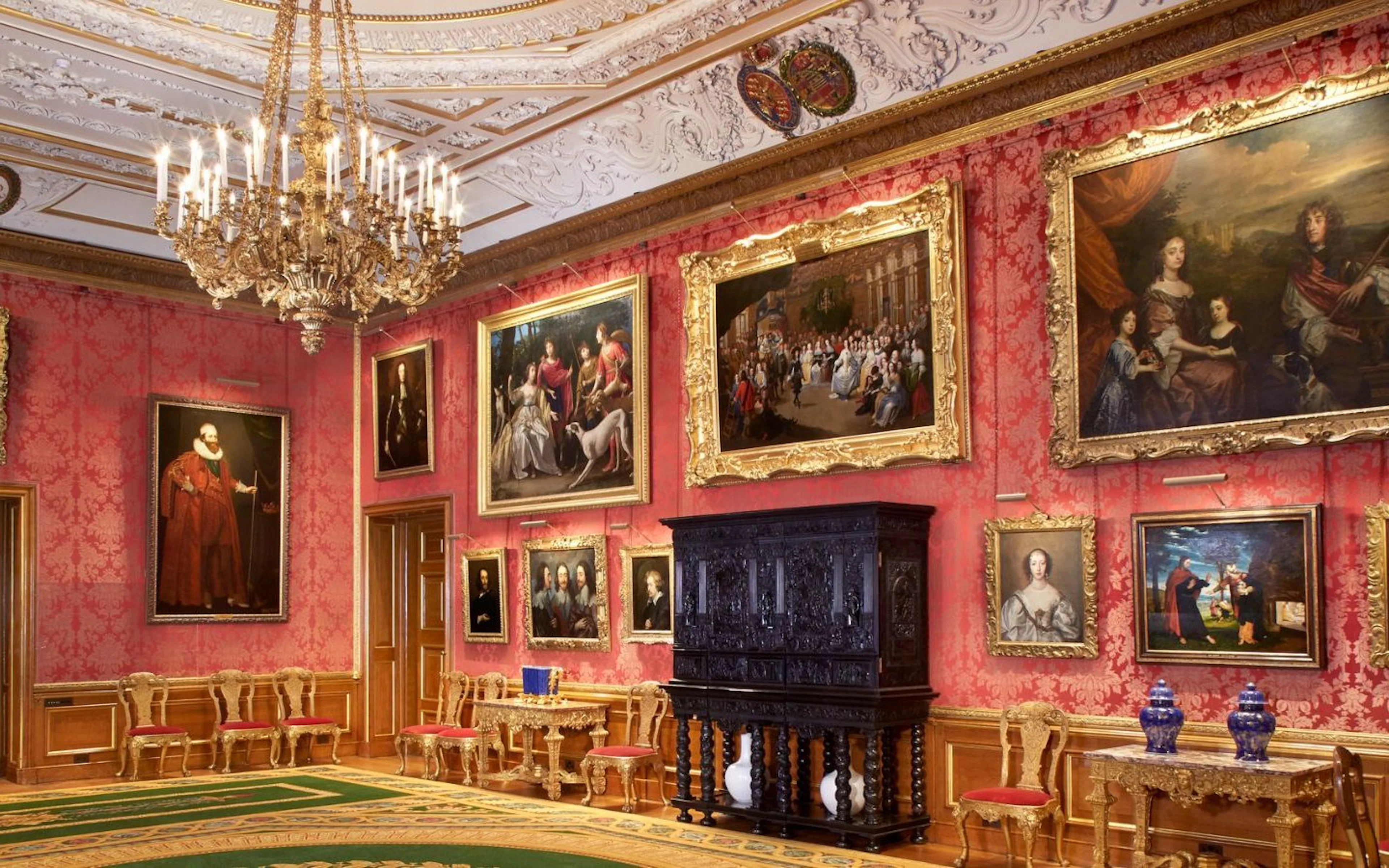 Windsor Castle interior with ornate paintings and chandelier.