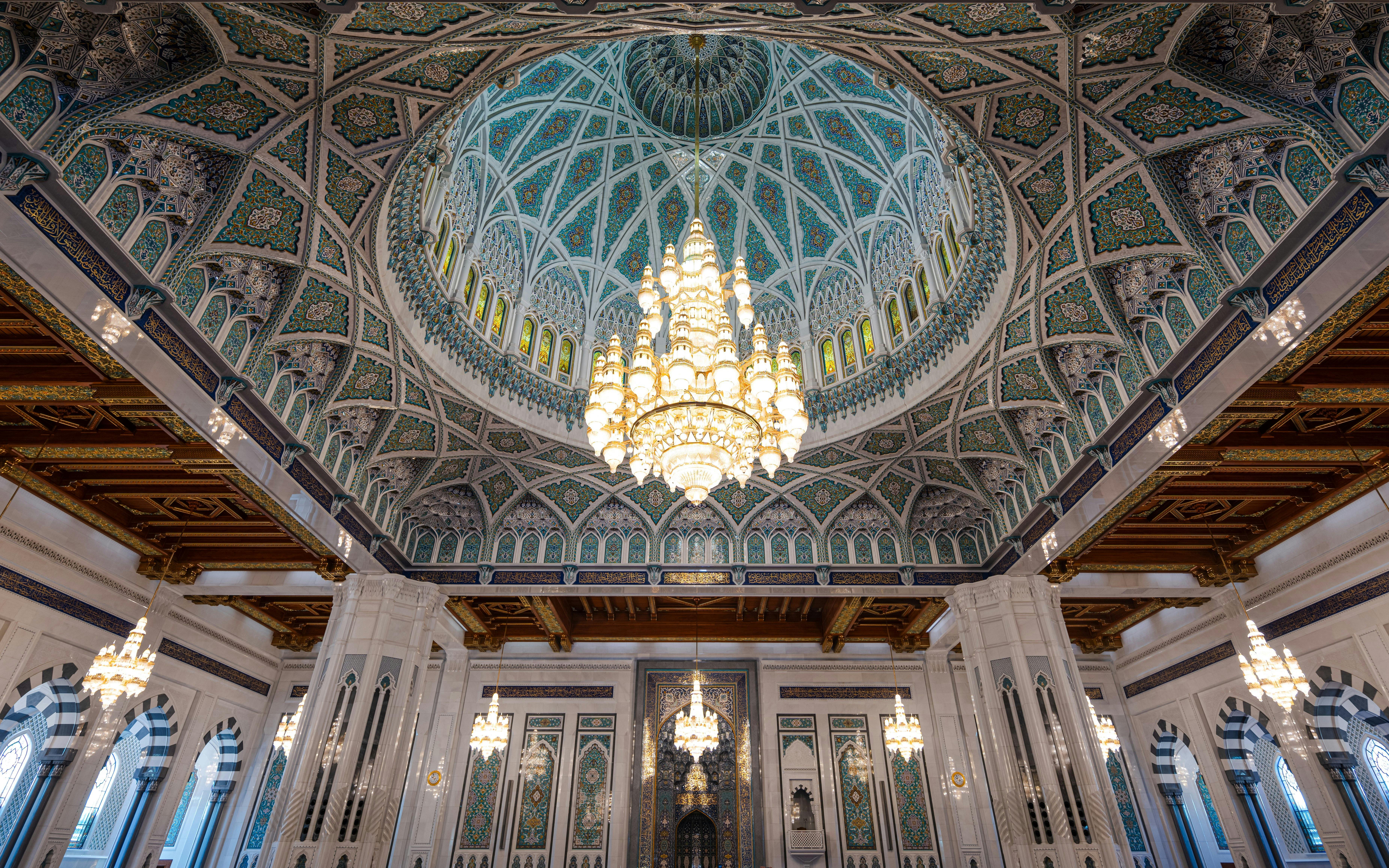 Chandelier and ornate dome inside Sultan Qaboos Grand Mosque, Muscat, Oman.