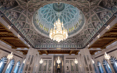 Chandelier and ornate dome inside Sultan Qaboos Grand Mosque, Muscat, Oman.