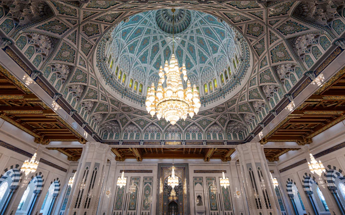 Chandelier and ornate dome inside Sultan Qaboos Grand Mosque, Muscat, Oman.