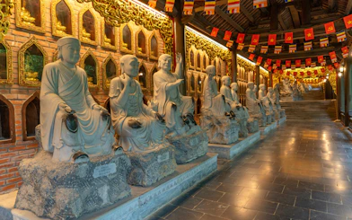 Buddha statues line the corridor leading to Bai Dinh Pagoda in Ninh Binh, Vietnam.