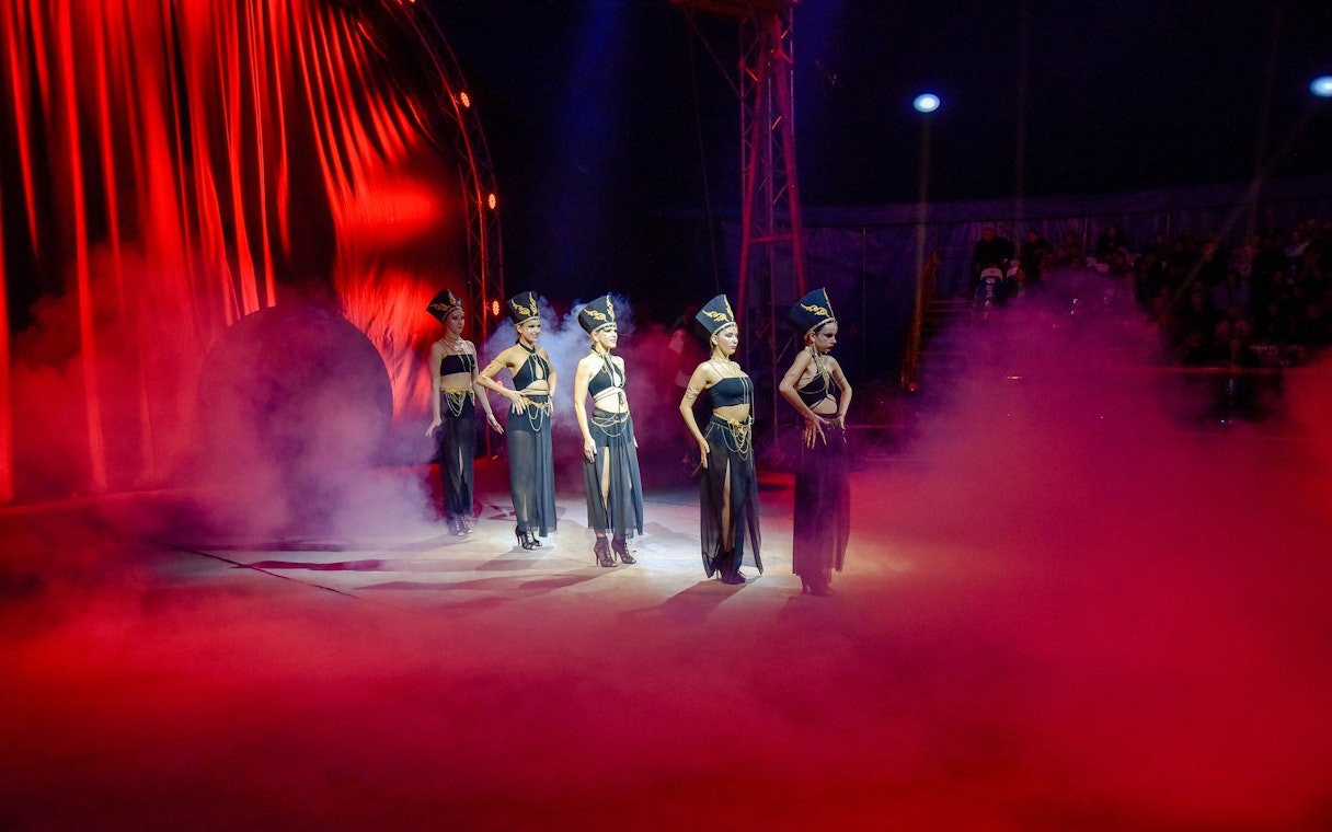 Performers in elaborate costumes on stage at Aqua Circus Phuket.