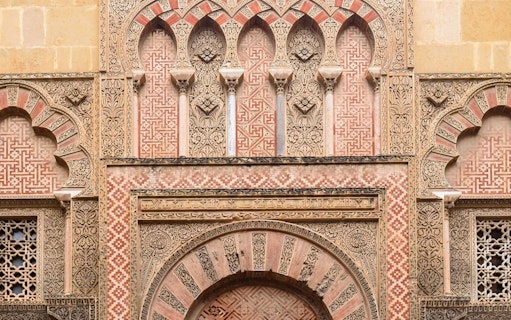 Side gate of Mezquita Cathedral in Cordoba with intricate Moorish designs.