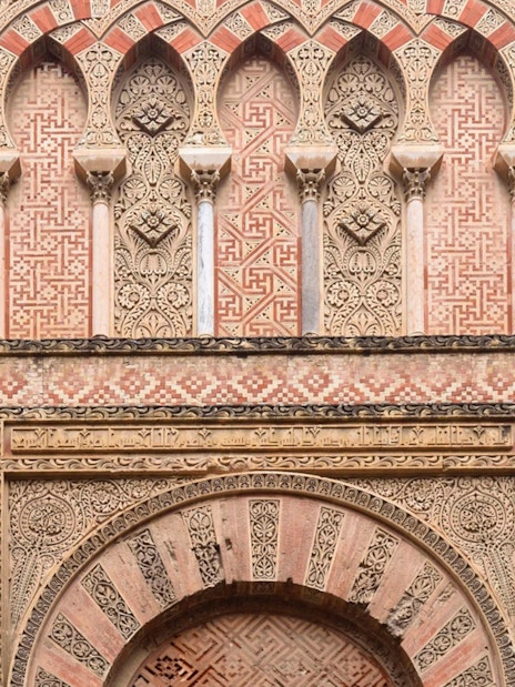 Side gate of Mezquita Cathedral in Cordoba with intricate Moorish designs.