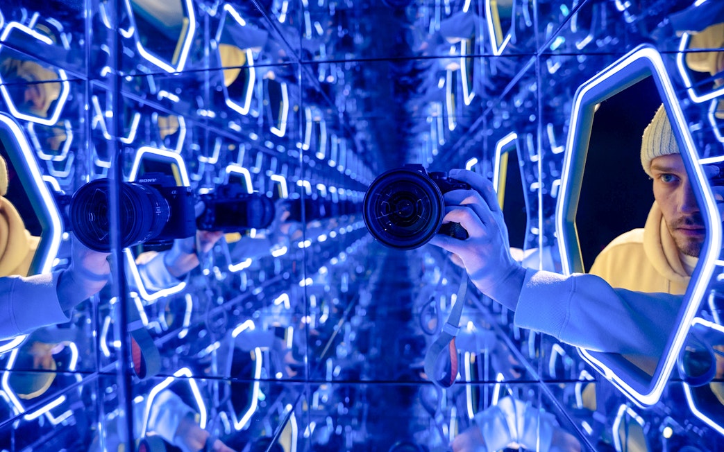 Mirrored room with neon lights at World Of Illusions exhibit.