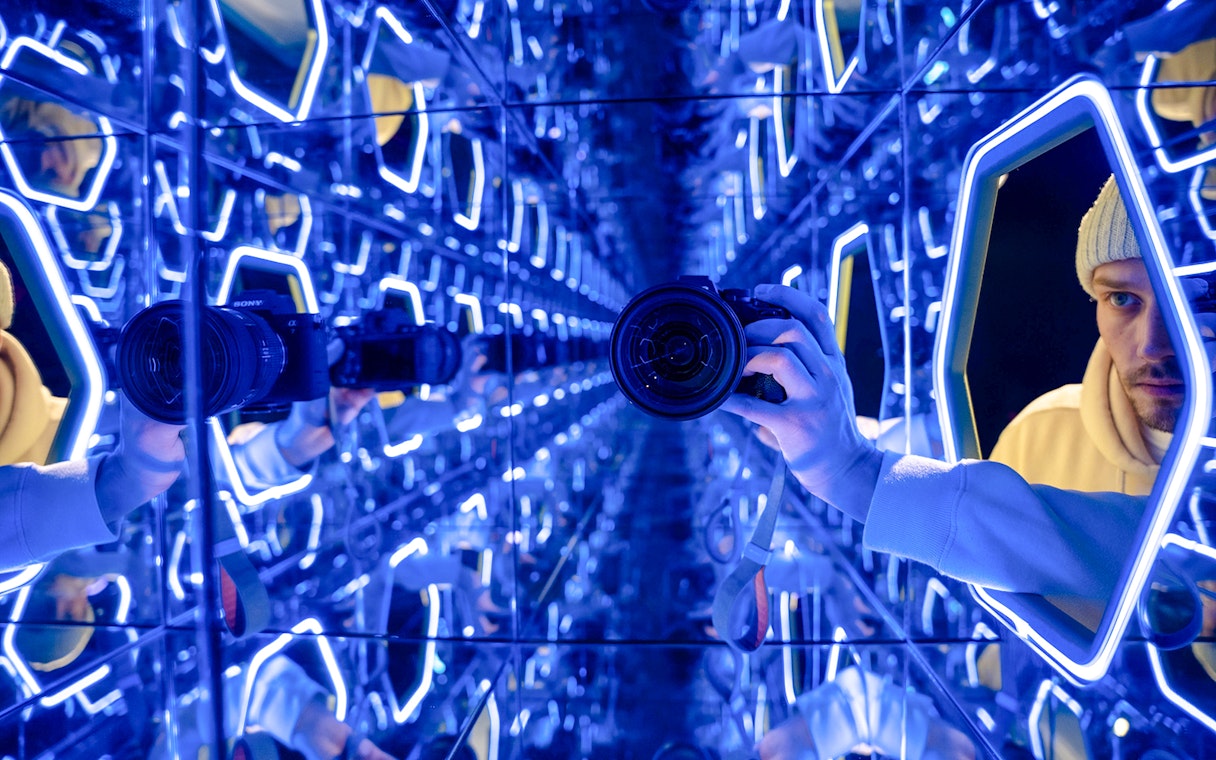 Mirrored room with neon lights at World Of Illusions exhibit.